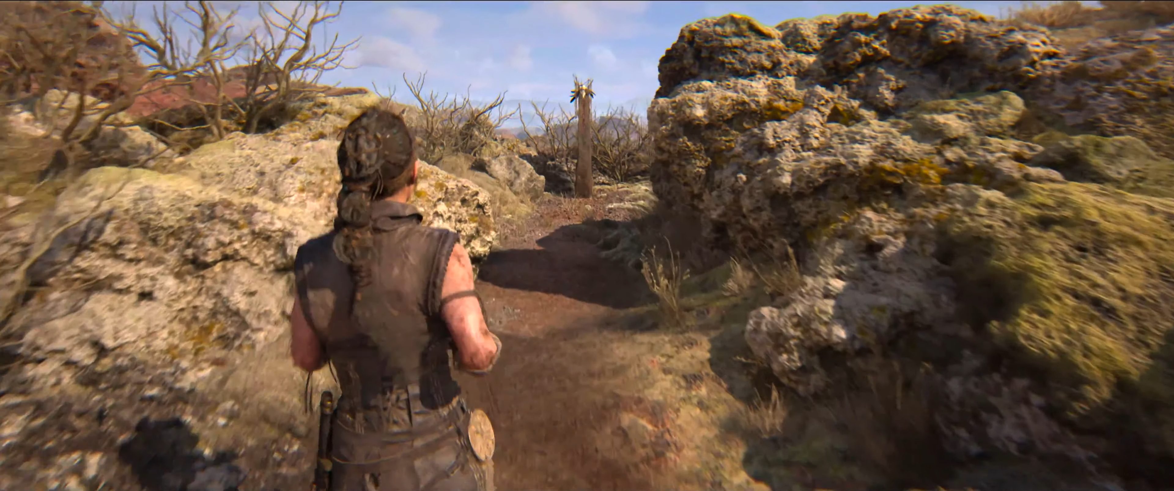 Senua approaching a lore totem in Hellblade 2.