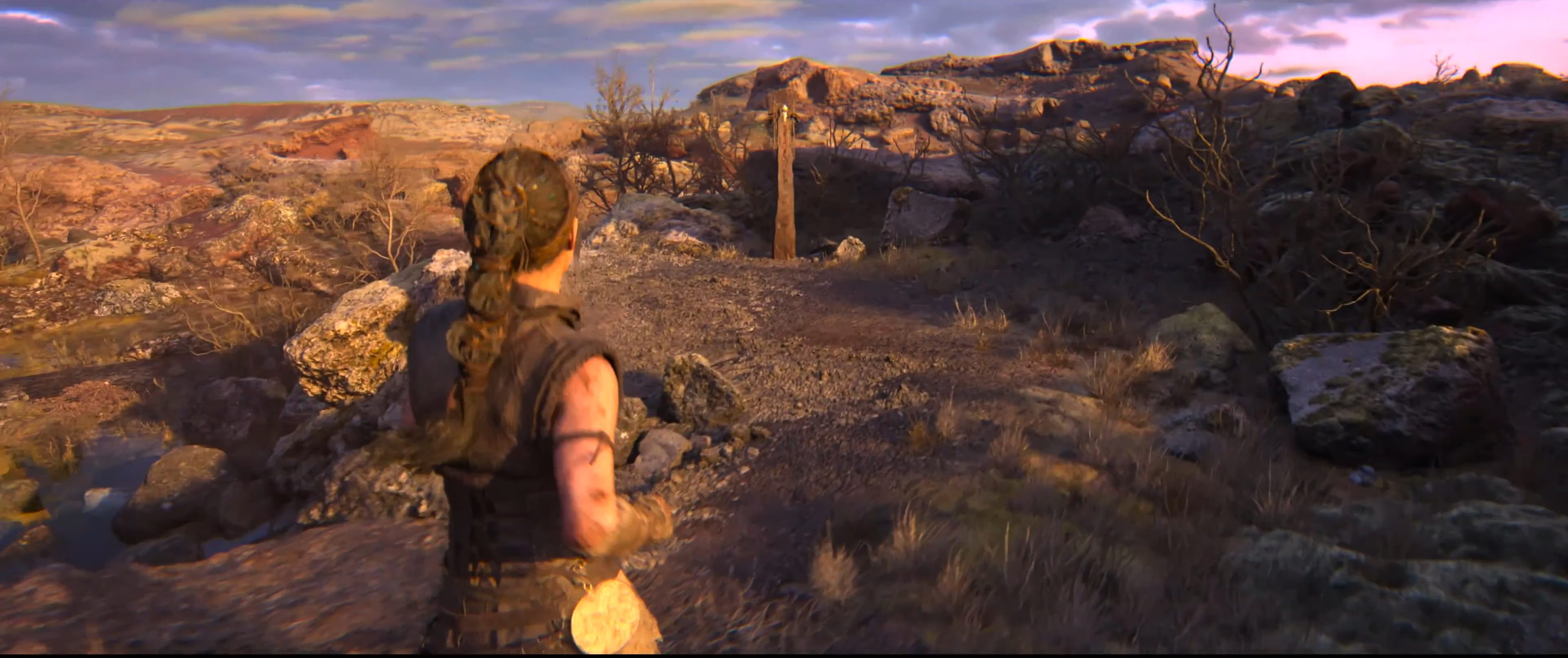 Senua approaching a lore totem in Hellblade 2.