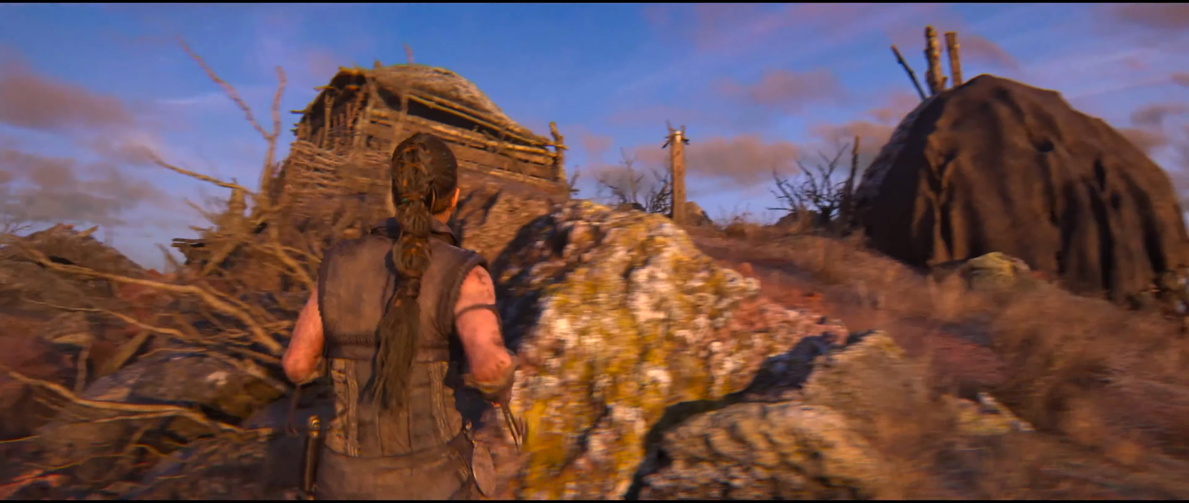 Senua approaching a lore totem in Hellblade 2.