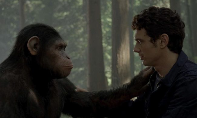 James Franco and an ape embrace with arms on each other.