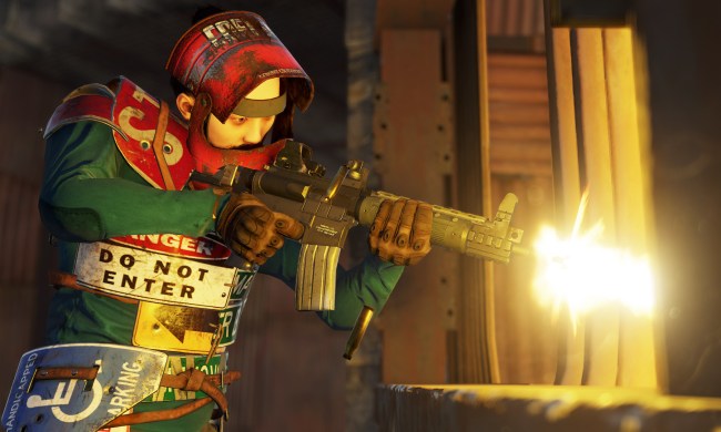 A player firing an assault rifle in Rust