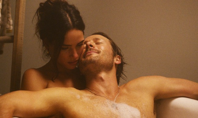 A man and a woman soak in a bathtub in Hit Man.