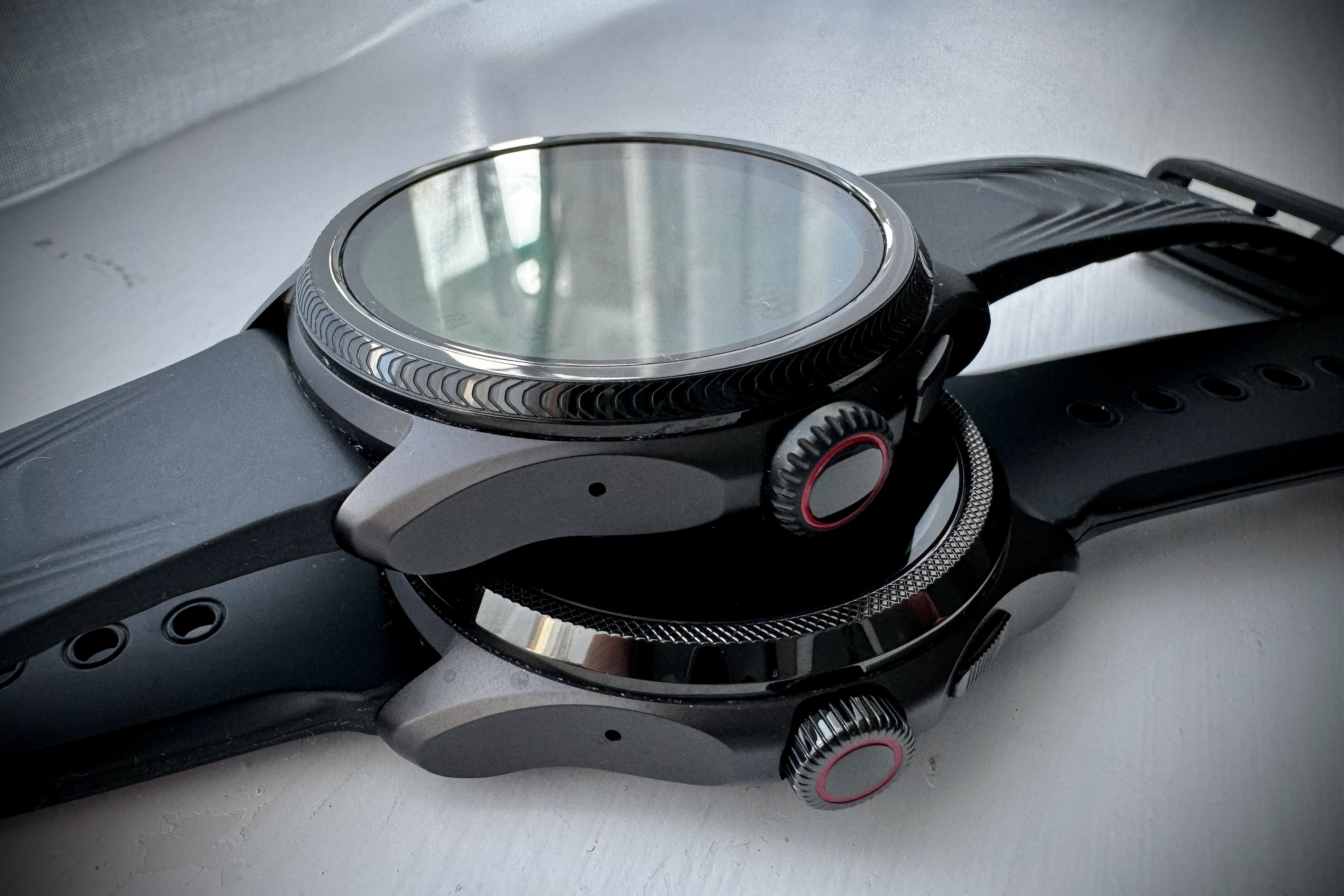 The Mobvoi TicWatch Pro 5 Enduro and the Mobvoi TicWatch Pro 5's bezels and crowns.